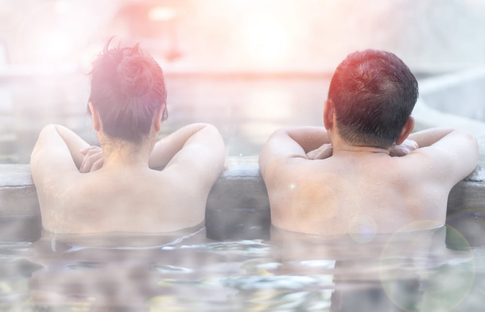 a couple enjoying a soak in New Mexico hot springs